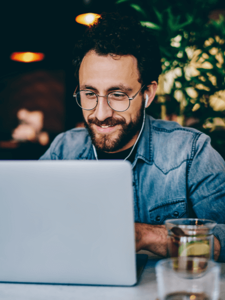 Person using TotalAV&trade; in a coffee shop